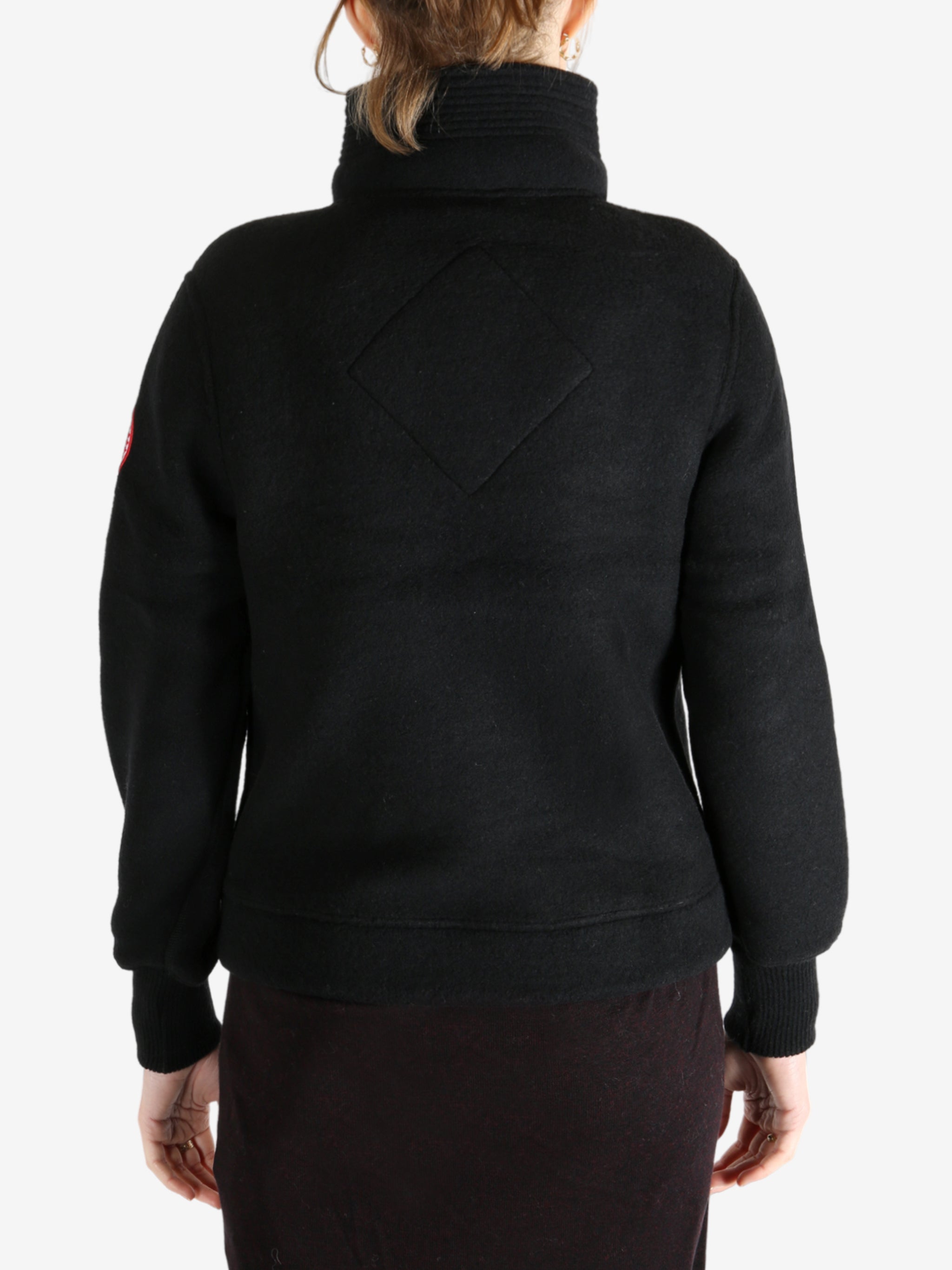 Black jacket worn by a person, showing the jacket fit