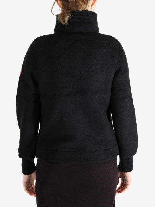 Black jacket worn by a person, showing the jacket fit