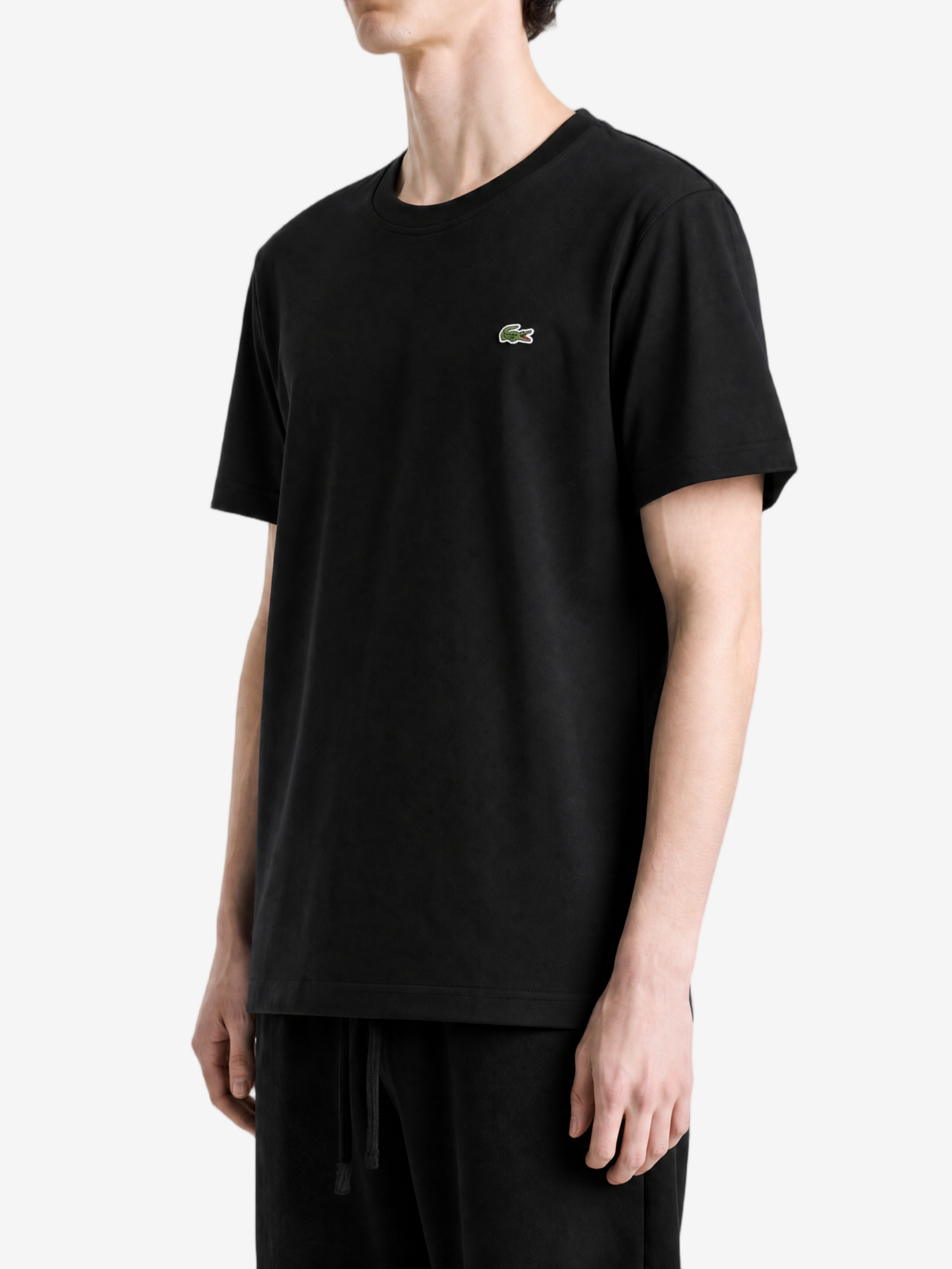 Black t-shirt worn by a person, showing the t-shirt fit