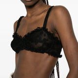 Black top worn by a person, showing the top fit