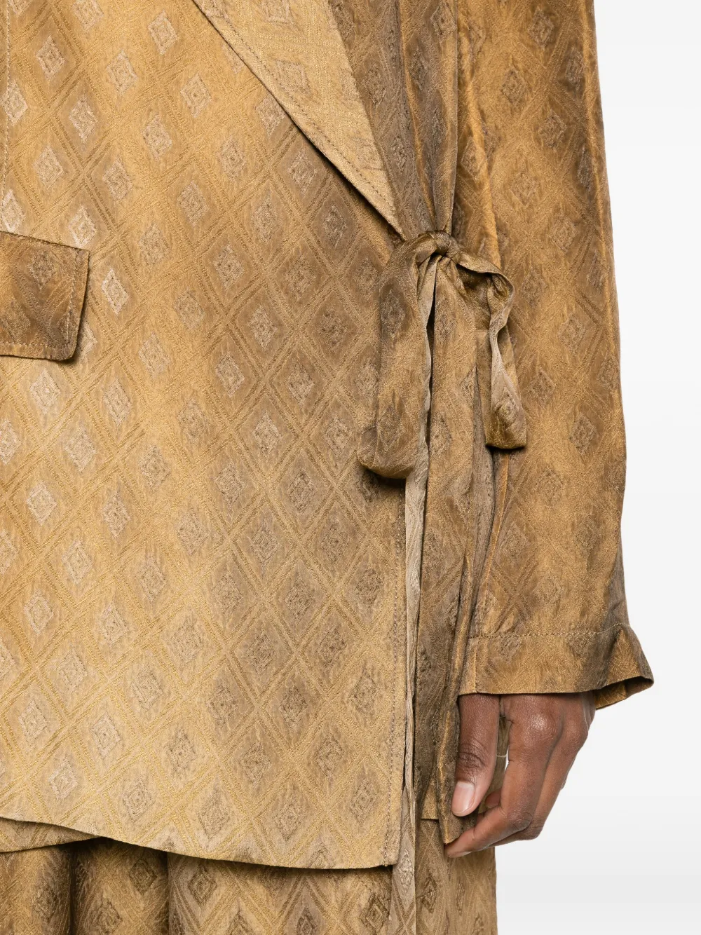 Close up of brown jacket,showing texture of the cupro fabric.