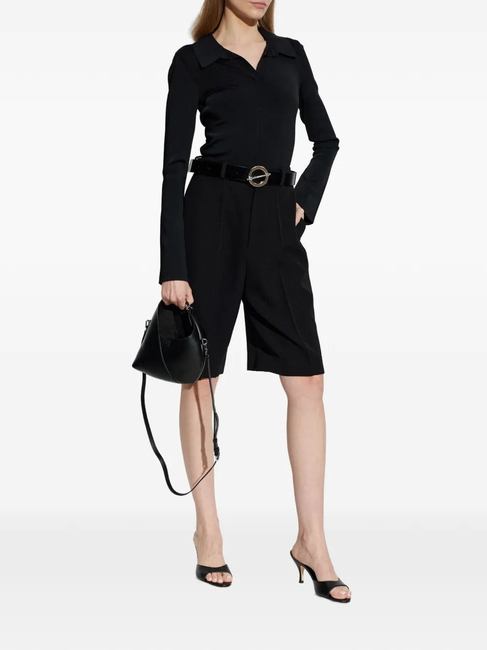 Black top worn by a person, showing the top's fit