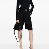 Black top worn by a person, showing the top's fit
