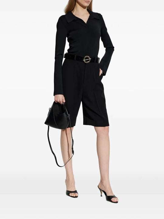 Black top worn by a person, showing the top's fit