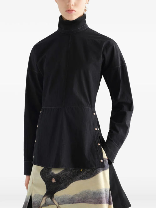 Black top worn by a person, showing the top fit