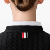 Close up of black cardigan, showing texture of the cashmere fabric