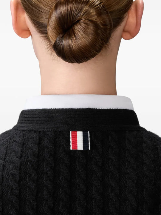 Close up of black cardigan, showing texture of the cashmere fabric