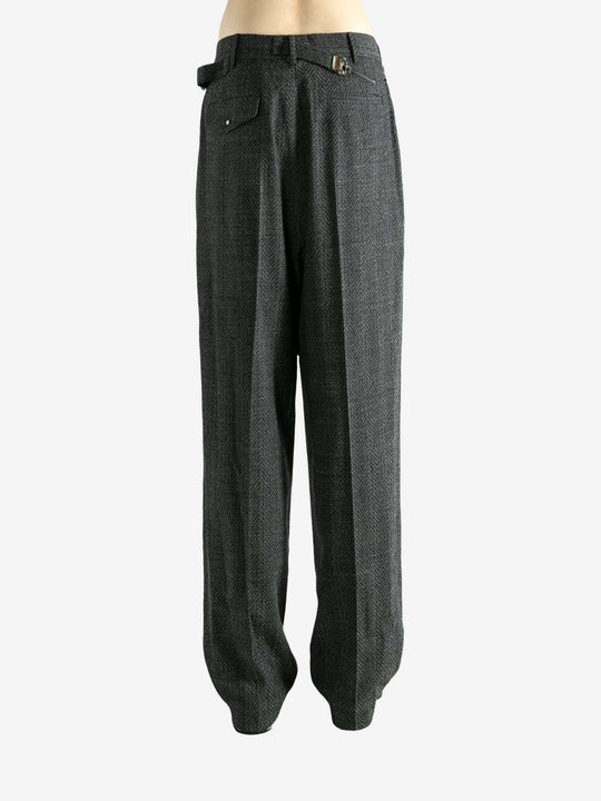 Black pants worn by a person, showing the pants fit