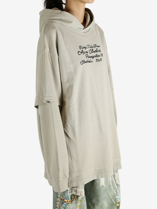 Tan hoodie worn by a person, showing the hoodie's fit