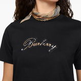 Black t-shirts worn by a person, showing the t-shirts fit