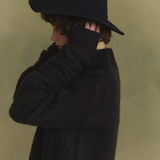 Navy knitwear worn by a person, showing the knitwear's fit