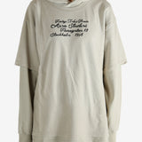 Tan hoodie worn by a person, showing the hoodie's fit