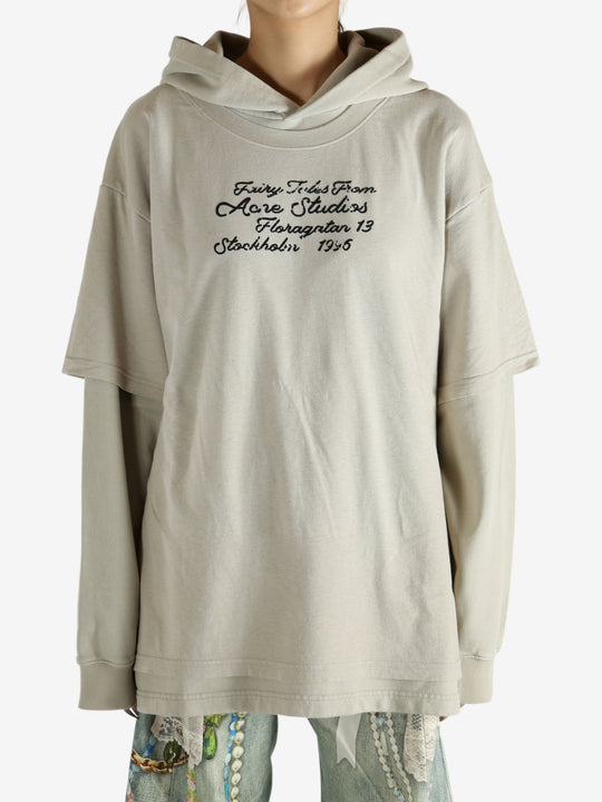 Tan hoodie worn by a person, showing the hoodie's fit