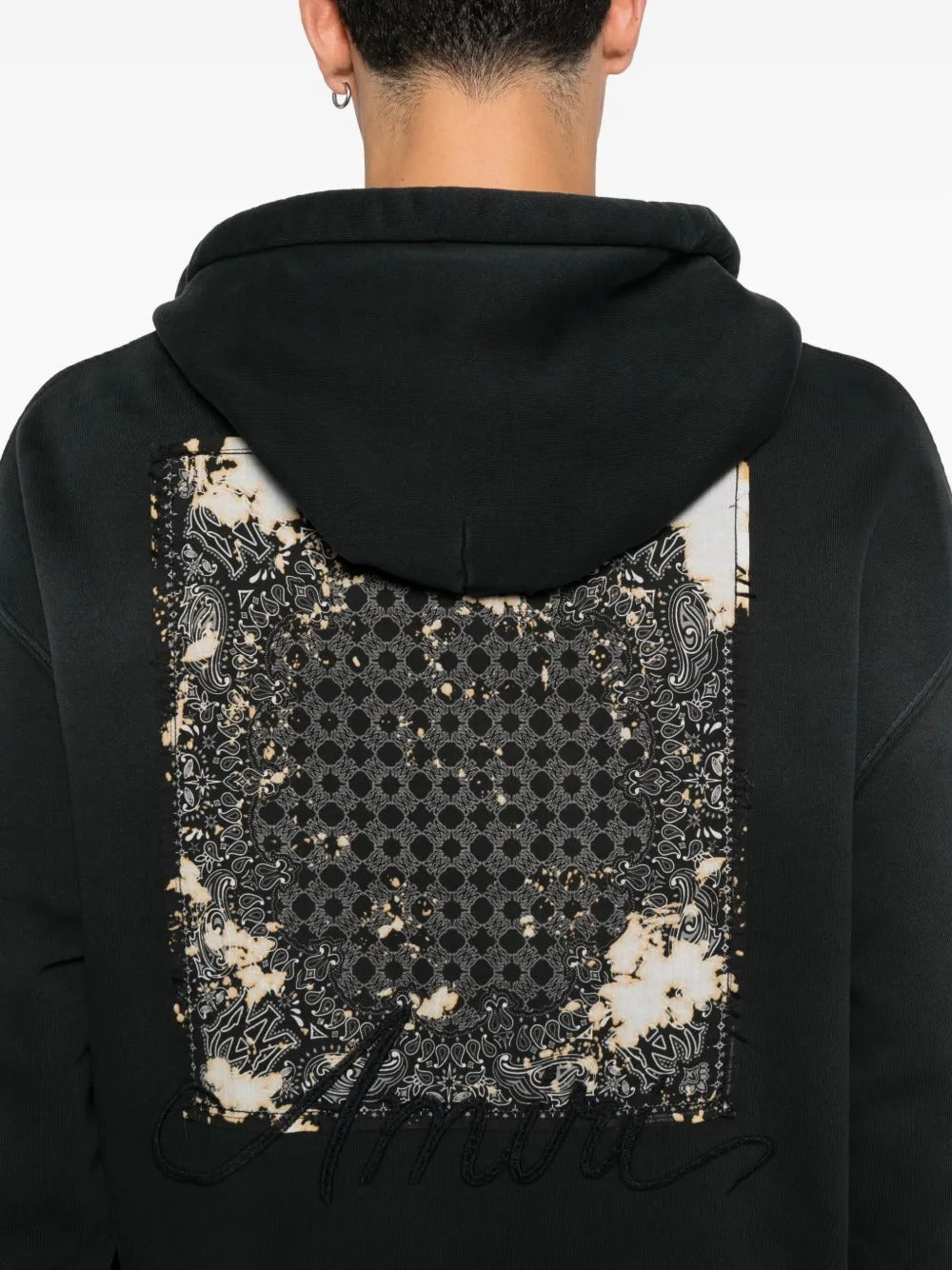 Close up of black hoodie, showing texture of the cotton fabric