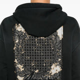 Close up of black hoodie, showing texture of the cotton fabric