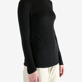 Black t-shirt worn by a person, showing the shirt's fit