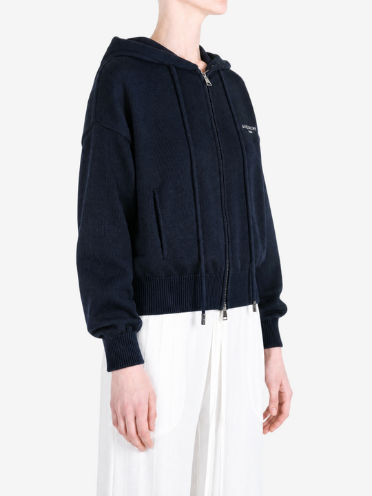 Navy hoodie worn by a person, showing the hoodie fit