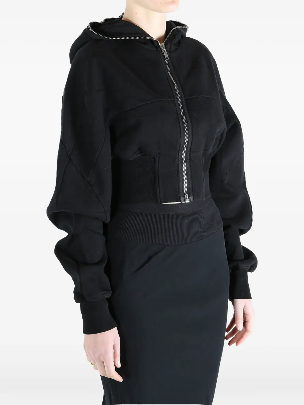 Black hoodie worn by a person, showing the  hoodie fit