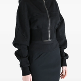 Black hoodie worn by a person, showing the  hoodie fit