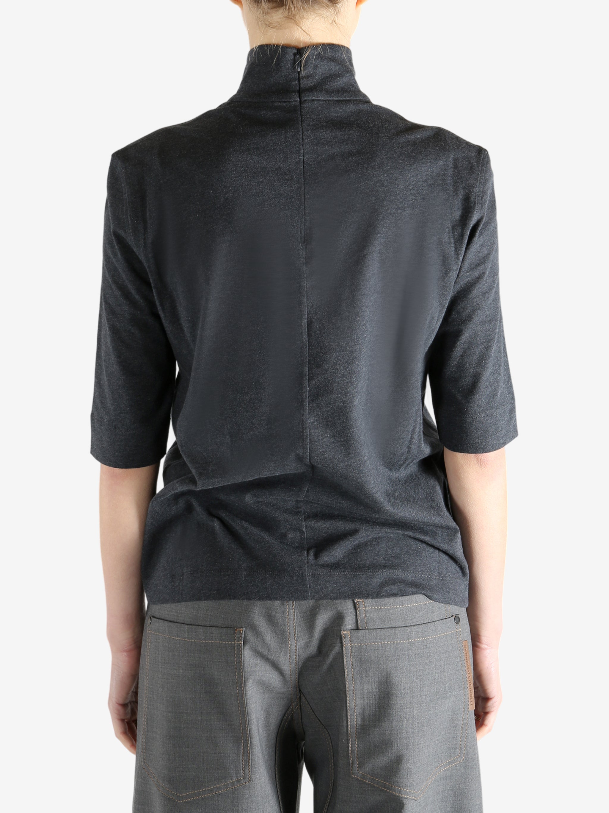 Grey t-shirts worn by a person, showing the t-shirts fit