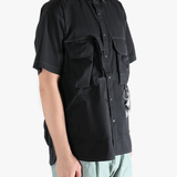 Black shirts worn by a person, showing the shirts fit