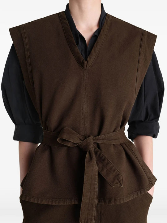 Brown top worn by a person, showing the top's fit