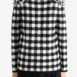 Black sweater worn by a person, showing the knitwear's fit