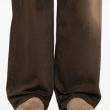 Close up of brown pants, showing texture of the cotton fabric