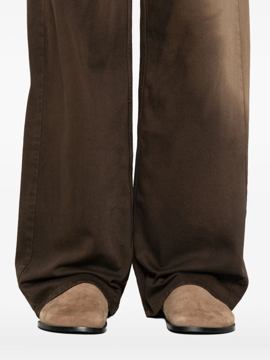 Close up of brown pants, showing texture of the cotton fabric