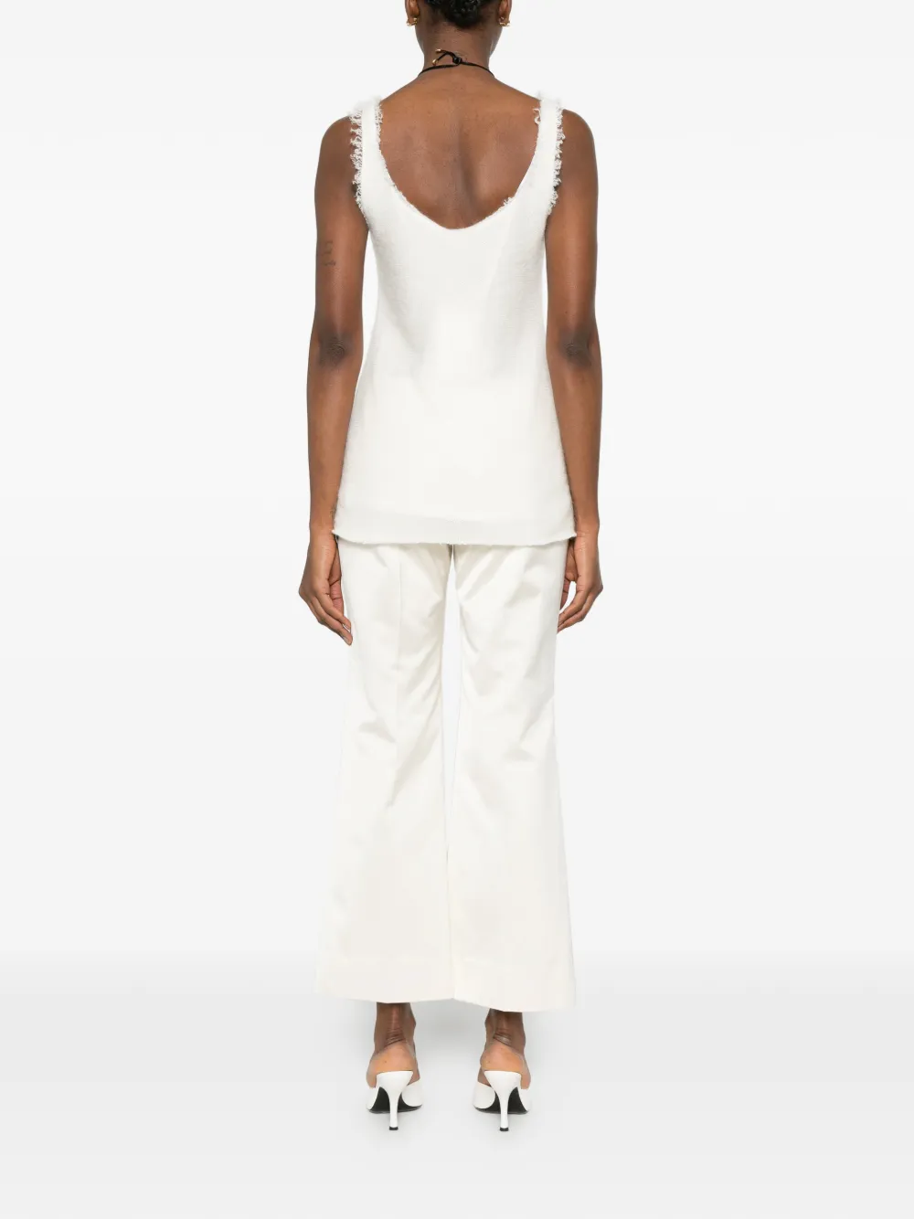 White tops worn by a person, showing the tops' fit
