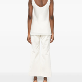 White tops worn by a person, showing the tops' fit