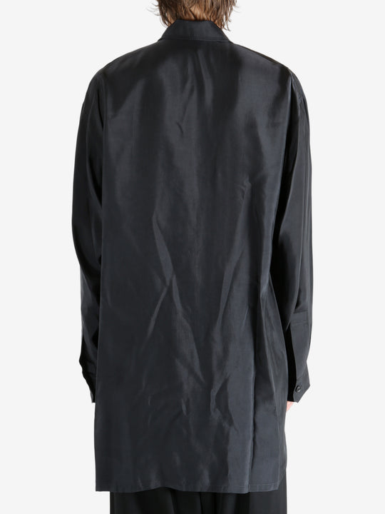 Black shirt worn by a person, showing the shirt's fit