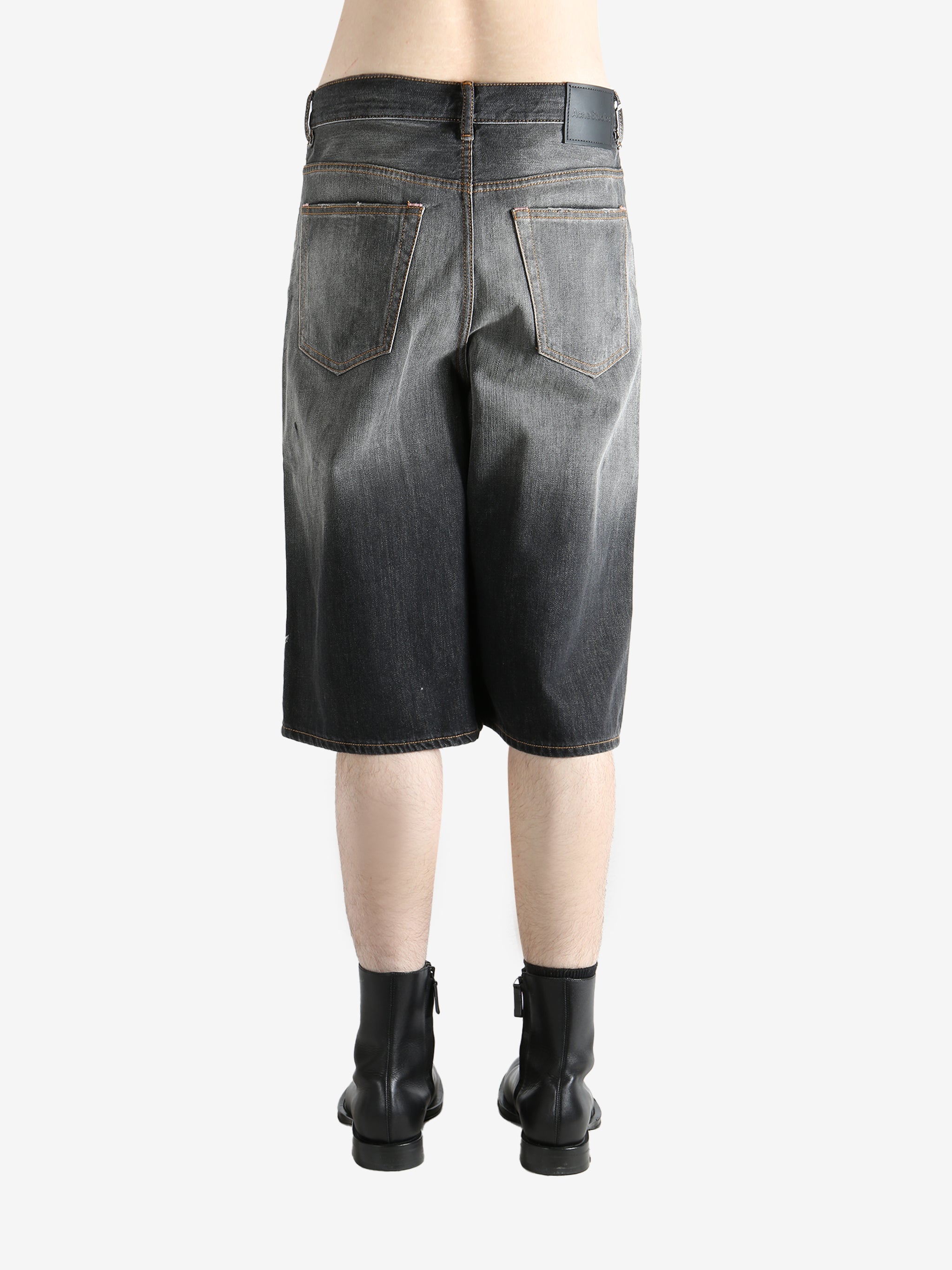 Black shorts worn by a person, showing the shorts's fit