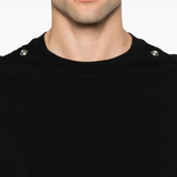 Close up of the black t-shirt, showing texture of the cotton fabric