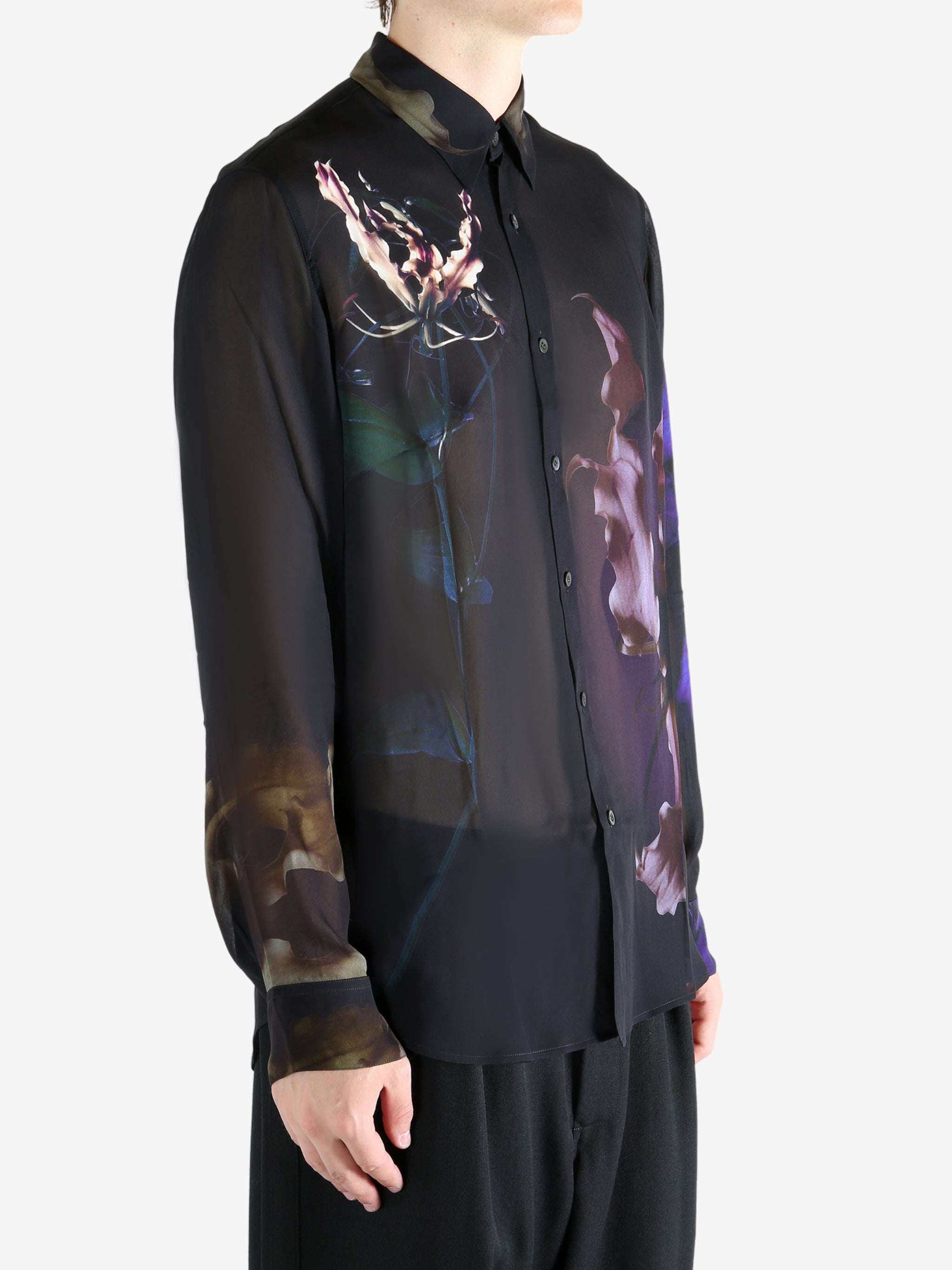 Black shirt worn by a person, showing the shirt's fit