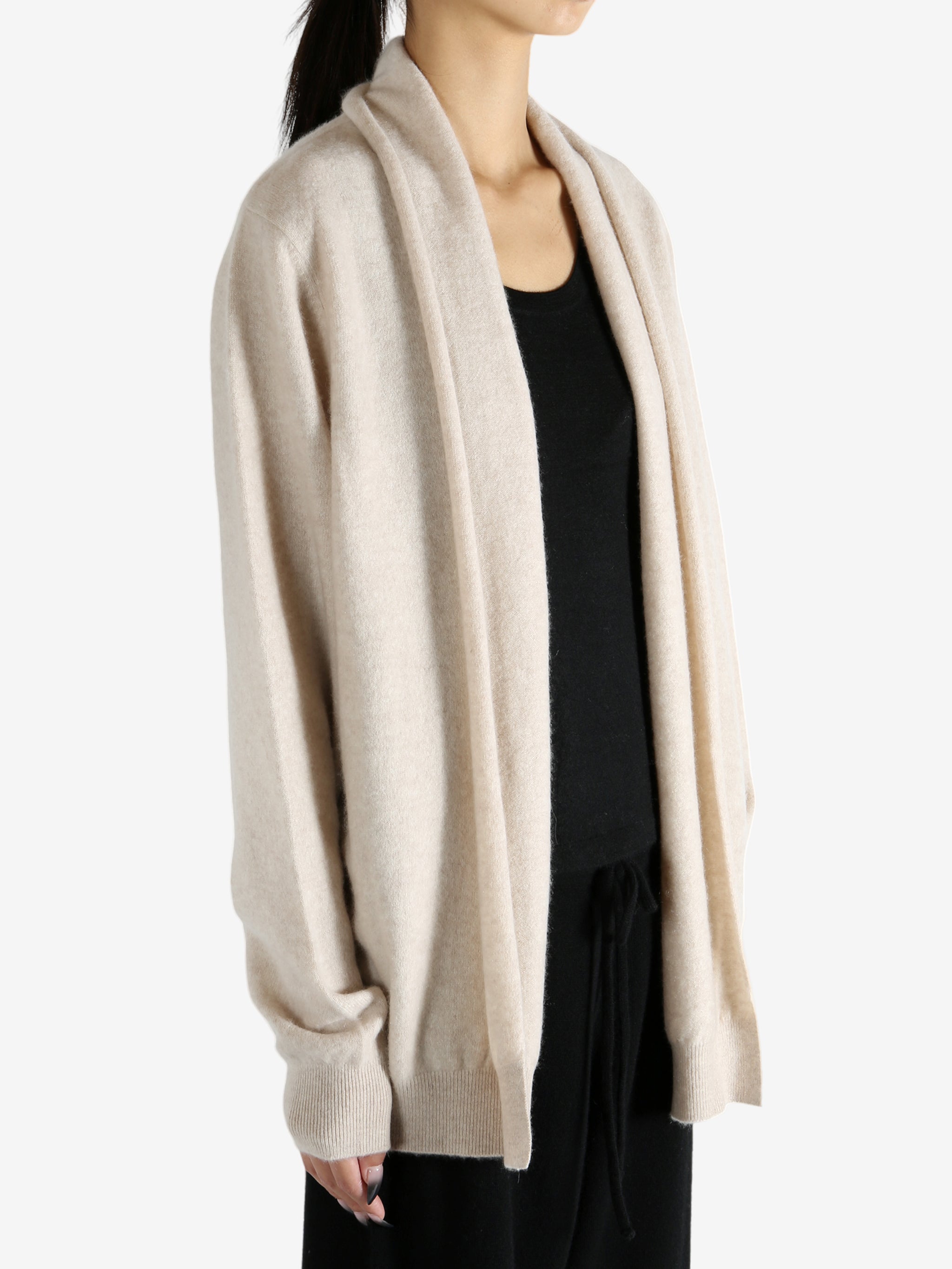 Tan cardigan worn by a person, showing the cardigan's fit