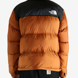 Orange jacket worn by a person, showing the jacket's fit