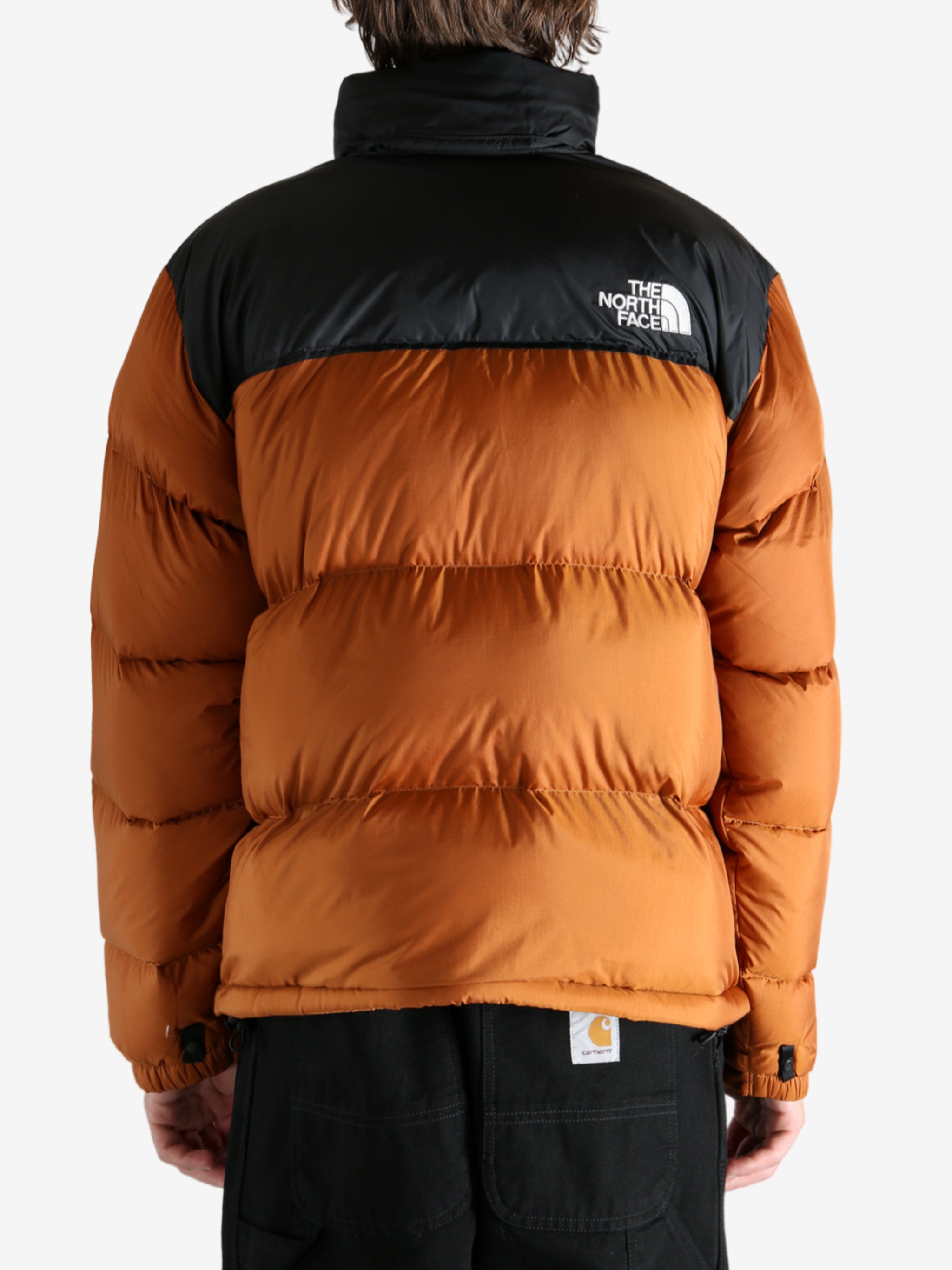 Orange jacket worn by a person, showing the jacket's fit