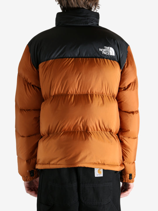 Orange jacket worn by a person, showing the jacket's fit