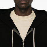 Black hoodie worn by a person, showing the hoodie fit
