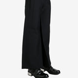 Black pants worn by a person, showing the pants's fit