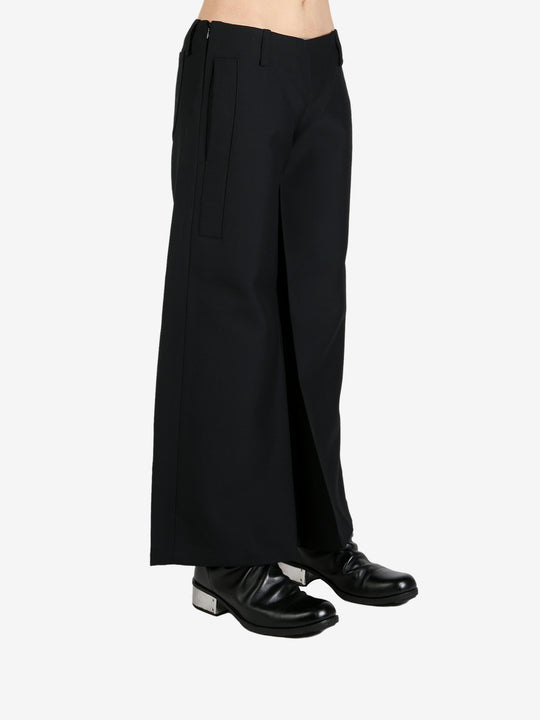 Black pants worn by a person, showing the pants's fit
