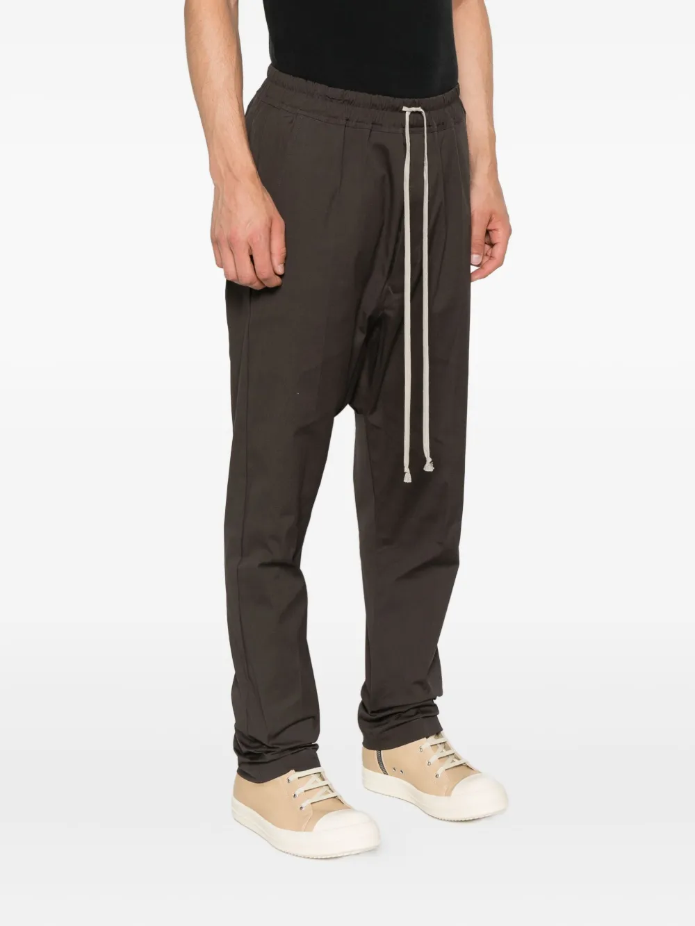 Black pants worn by a person, showing the pants' fit