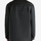 Black jacket worn by a person, showing the jacket fit