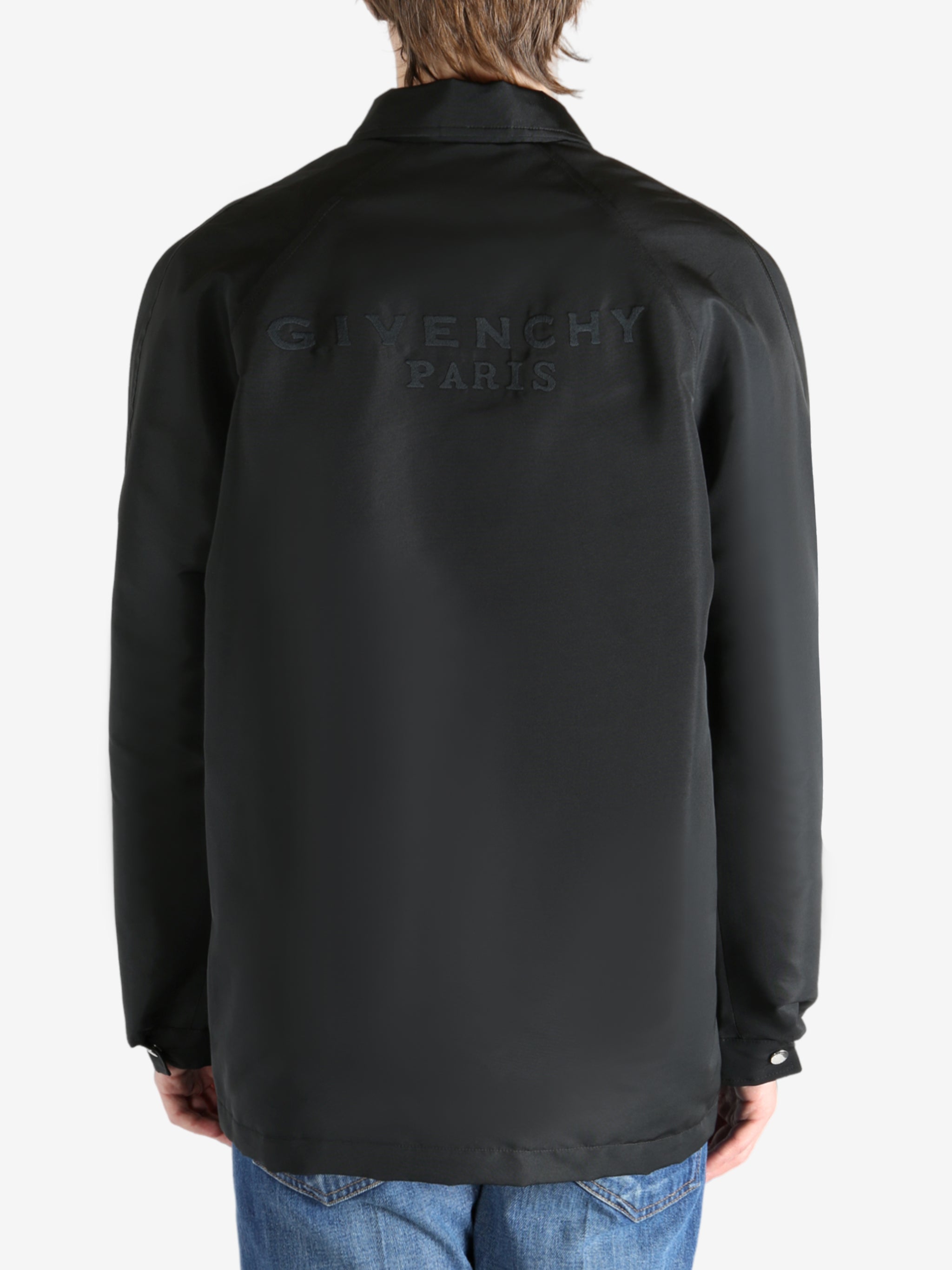 Black jacket worn by a person, showing the jacket fit