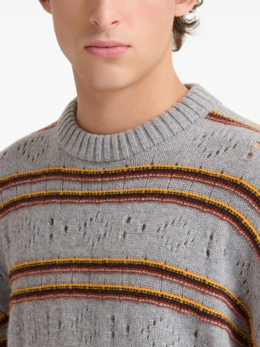 Grey knitwear worn by a person, showing the knitwear fit