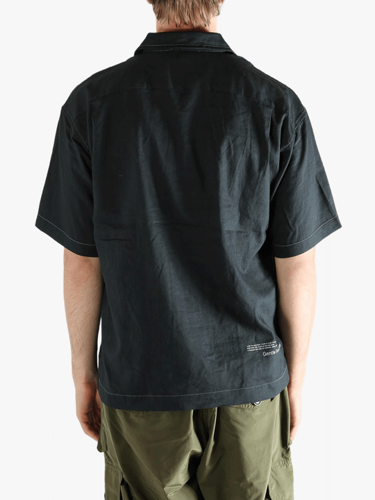 Black shirts worn by a person, showing the shirts fit