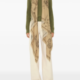 Tan scarf worn by a person, showing the scarf fit