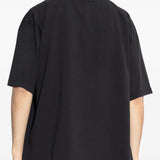 Black t-shirts worn by a person, showing the t-shirts fit