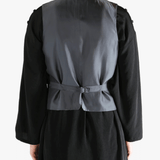 Black vest worn by a person, showing the vest's fit